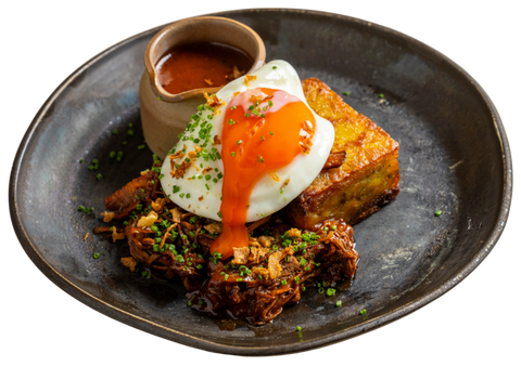 Dark plate with hash brown beef brisket and fried egg